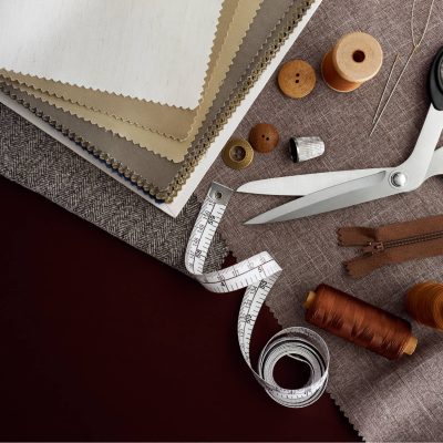 Brown haberdashery items; fabrics, tailors scissors, threads, buttons, tape. Lindsay's Textiles. Blinds, curtains, net curtains, voiles. Warminster, Wiltshire